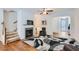 Inviting living room with a fireplace, hardwood floors, and staircase to the upper level at 5036 Longview Walk, Decatur, GA 30035