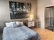 Cozy bedroom with stylish decor, hardwood floors, and an adjacent bathroom with shower at 878 Peachtree Ne St # 608, Atlanta, GA 30309