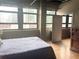 Bedroom featuring a large window with city views, wood floors, and an ensuite bathroom at 878 Peachtree Ne St # 608, Atlanta, GA 30309