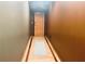 Warm-toned hallway with modern flooring leads to a door, creating an inviting transition space at 878 Peachtree Ne St # 608, Atlanta, GA 30309