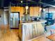 The kitchen features wood cabinetry, stainless steel appliances and a breakfast bar for casual dining at 878 Peachtree Ne St # 608, Atlanta, GA 30309