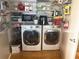 Well-organized laundry area with washer, dryer, and ample shelving for storage solutions at 878 Peachtree Ne St # 608, Atlanta, GA 30309