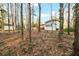 Mature trees surround the home's backyard, complemented by a detached shed at 220 Mimosa Dr, Fayetteville, GA 30214