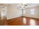 Bedroom featuring hardwood floors, crown molding, neutral paint, and two windows at 220 Mimosa Dr, Fayetteville, GA 30214