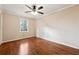 Bedroom featuring hardwood flooring, crown molding, and a window at 220 Mimosa Dr, Fayetteville, GA 30214