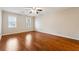 Bedroom with hardwood flooring, crown molding, and neutral paint, providing a cozy atmosphere at 220 Mimosa Dr, Fayetteville, GA 30214