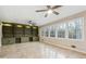 Bright bonus room features built-in bookshelves, a ceiling fan, and large windows with wooded views at 220 Mimosa Dr, Fayetteville, GA 30214