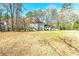 Well-maintained two-story home on a large lot surrounded by mature trees and a spacious front yard at 220 Mimosa Dr, Fayetteville, GA 30214