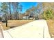 Inviting two-story home with a long driveway and a well-manicured lawn in a wooded setting at 220 Mimosa Dr, Fayetteville, GA 30214