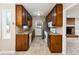 Efficient kitchen layout with dark wood cabinets, stainless steel appliances, and a view into the living space at 220 Mimosa Dr, Fayetteville, GA 30214