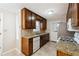 Updated kitchen with dark wood cabinets, granite countertops, and stainless steel appliances at 220 Mimosa Dr, Fayetteville, GA 30214