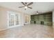 Spacious living room featuring a tiled floor, built-in shelving, and double French doors at 220 Mimosa Dr, Fayetteville, GA 30214