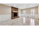 Bright living room with a brick fireplace and mantel, as well as tile flooring and natural light from the windows at 220 Mimosa Dr, Fayetteville, GA 30214