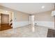 Neutral living room with fireplace, tile floor, white wainscoting, and view into other rooms at 220 Mimosa Dr, Fayetteville, GA 30214