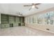 Bright living room featuring a large window, built-in shelving, and a ceiling fan at 220 Mimosa Dr, Fayetteville, GA 30214