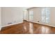 Cozy living room showcasing hardwood floors and views from its shuttered windows at 220 Mimosa Dr, Fayetteville, GA 30214