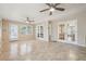 Sunroom features tiled flooring, dual ceiling fans, and french doors at 220 Mimosa Dr, Fayetteville, GA 30214