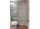Bathroom featuring new commode, shower with glass doors and tile surround at 2398 Lawrenceville Hwy # K, Decatur, GA 30033