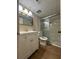 Bright bathroom featuring a vanity, commode, tile surround, and glass shower doors at 2398 Lawrenceville Hwy # K, Decatur, GA 30033