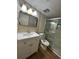 Bathroom featuring a large vanity, updated fixtures, commode, and glass shower doors at 2398 Lawrenceville Hwy # K, Decatur, GA 30033