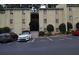The exterior of this tan two-story condominium building features a dark awning and visitor parking at 2398 Lawrenceville Hwy # K, Decatur, GA 30033