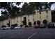 The exterior of this two-story tan condominium building features visitor parking at 2398 Lawrenceville Hwy # K, Decatur, GA 30033