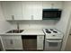 Well-appointed kitchen with modern appliances, white cabinets, and stainless steel sink at 2398 Lawrenceville Hwy # K, Decatur, GA 30033