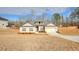 Attractive one-story brick home with a two-car garage, neatly landscaped yard, and blue skies above at 1006 Alcovy River Ct, Loganville, GA 30052