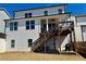 View of the backyard featuring a second story deck, stairs, and a grilling area at 108 Fieldbrook Xing, Holly Springs, GA 30115