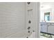 Bathroom with white subway tile surrounding a tub and shower combo, as well as gray cabinets at 108 Fieldbrook Xing, Holly Springs, GA 30115