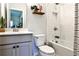 Cozy bathroom featuring a tub and shower combo, white subway tile and gray vanity at 108 Fieldbrook Xing, Holly Springs, GA 30115