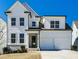 Charming two-story home with a two car garage and a welcoming green front door at 108 Fieldbrook Xing, Holly Springs, GA 30115