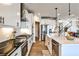 A modern kitchen with stainless steel appliances, white cabinetry, and a center island with a sink at 108 Fieldbrook Xing, Holly Springs, GA 30115