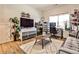 Spacious room has hardwood flooring, sofa, desk, and shelving at 108 Fieldbrook Xing, Holly Springs, GA 30115