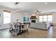 Bright open-concept living and dining area, showcasing a fireplace and modern furnishings at 108 Fieldbrook Xing, Holly Springs, GA 30115