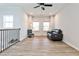 Spacious living room featuring hard wood flooring, lots of light, and a ceiling fan at 108 Fieldbrook Xing, Holly Springs, GA 30115