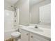 Well-lit bathroom with white fixtures including a tub-shower combo and vanity at 1559 Hillary Cove Ct, Lawrenceville, GA 30043