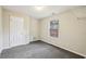 Comfortable bedroom featuring grey carpet, closet and plenty of natural light at 1559 Hillary Cove Ct, Lawrenceville, GA 30043