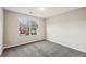 Empty bedroom featuring carpet, neutral paint, and a double-hung window at 1559 Hillary Cove Ct, Lawrenceville, GA 30043