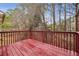 Exterior deck with wooden planking and railings surrounded by trees at 1559 Hillary Cove Ct, Lawrenceville, GA 30043