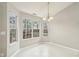 Bright dining area featuring a charming chandelier and lots of natural light from the many windows at 1559 Hillary Cove Ct, Lawrenceville, GA 30043