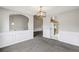 Dining room has wainscoting and neutral walls and is open to the entryway and eat-in kitchen at 1559 Hillary Cove Ct, Lawrenceville, GA 30043