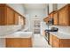 Well-lit kitchen with stainless steel appliances, wooden cabinets, and bright countertops at 1559 Hillary Cove Ct, Lawrenceville, GA 30043