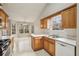 Bright eat-in kitchen has wood cabinets, white countertops, a sink, and a breakfast area with backyard views at 1559 Hillary Cove Ct, Lawrenceville, GA 30043