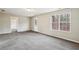 Spacious living room featuring a large window and neutral carpet and paint at 1559 Hillary Cove Ct, Lawrenceville, GA 30043