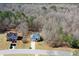 Aerial view of a home, showcasing its location within a wooded area, driveway, and neighborhood at 305 Long Creek Dr, Covington, GA 30016