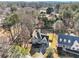 Aerial view of a two-story home with a well-maintained lawn and mature trees in a desirable neighborhood at 3170 Wood Springs Sw Trce, Lilburn, GA 30047