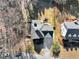 An aerial view shows the home with a long driveway and the manicured lawn in the fenced-in backyard at 3170 Wood Springs Sw Trce, Lilburn, GA 30047