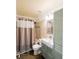 Cozy bathroom with tiled walls, a shower-tub combo, modern vanity, and neutral-toned accents at 3170 Wood Springs Sw Trce, Lilburn, GA 30047