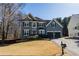 Charming two-story home with manicured front lawn, dark shutters and a two-car garage in a suburban neighborhood at 3170 Wood Springs Sw Trce, Lilburn, GA 30047